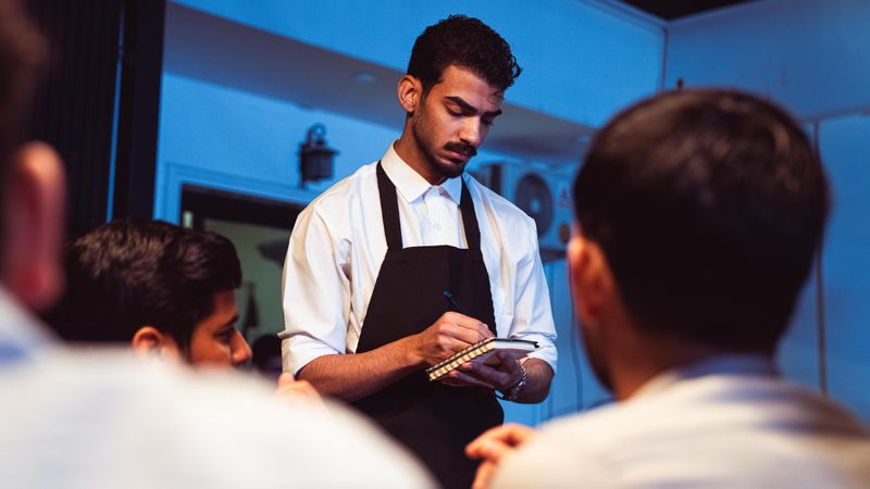 A waiter taking an order at a restaurant